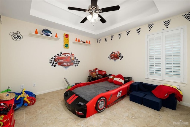 bedroom featuring a tray ceiling and ceiling fan