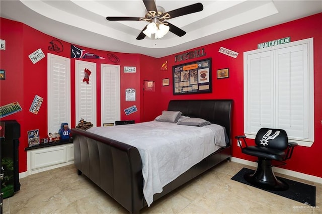 bedroom featuring a tray ceiling and ceiling fan