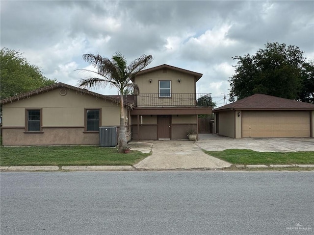 600 N Louisiana Ave N, Weslaco, TX 78596 - view of front facade featuring a garage, a balcony, central AC, an outdoor structure, and a front yard