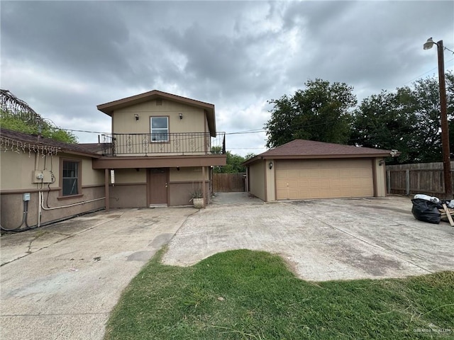 600 N Louisiana Ave N, Weslaco, TX 78596 - view of front of house featuring fence, a garage, an outbuilding, and a balcony