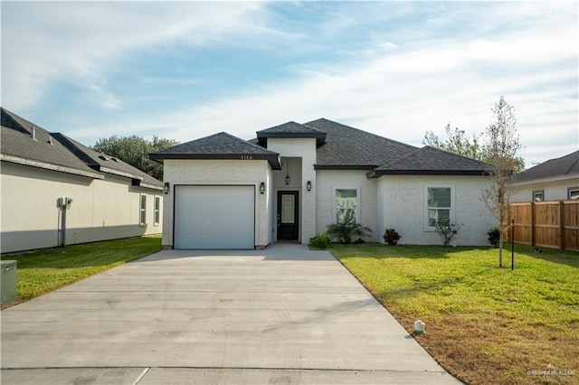 view of front of property featuring a garage and a front lawn