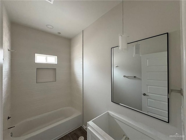 bathroom with wood finished floors and shower / washtub combination