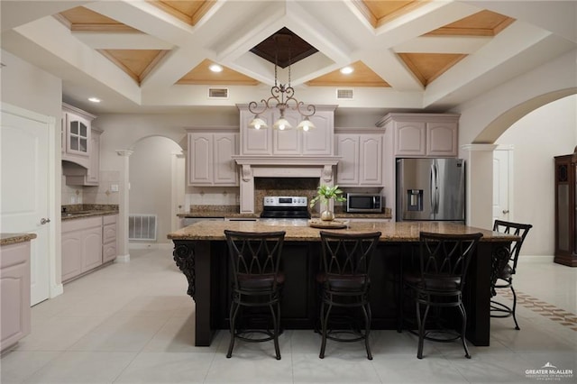 kitchen with appliances with stainless steel finishes, arched walkways, and visible vents