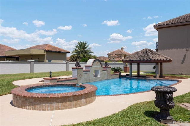 view of pool featuring a pool with connected hot tub, fence, and a gazebo