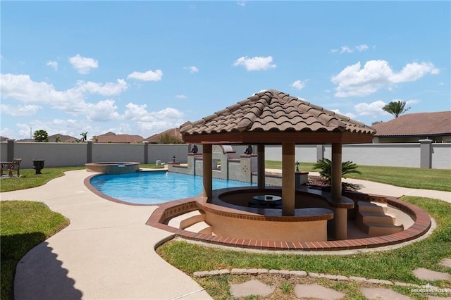 view of pool featuring a fenced backyard and a pool with connected hot tub