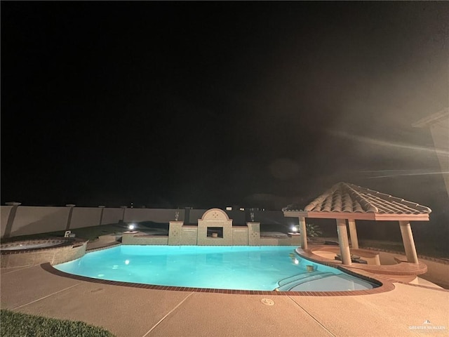 pool at twilight featuring an in ground hot tub, a patio area, a fenced in pool, and a gazebo