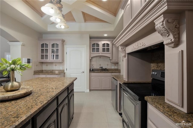 kitchen with tasteful backsplash, decorative columns, light stone countertops, stainless steel appliances, and light tile patterned flooring