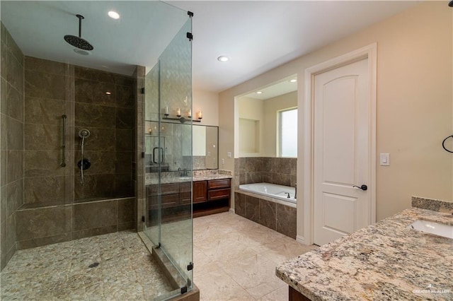 2014 Thacker Ln, Harlingen, TX 78552 - bathroom with vanity, a shower stall, a garden tub, recessed lighting, and tile patterned floors