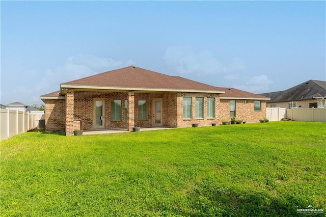 2014 Thacker Ln, Harlingen, TX 78552 - back of house with a fenced backyard, brick siding, and a patio area