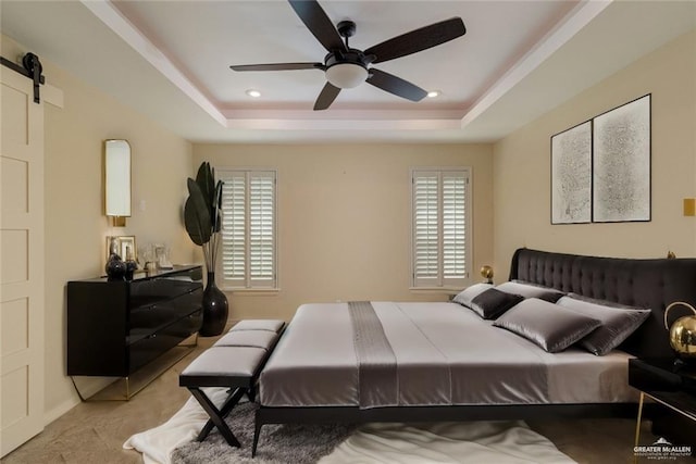 2014 Thacker Ln, Harlingen, TX 78552 - bedroom with a tray ceiling, multiple windows, a barn door, and a ceiling fan