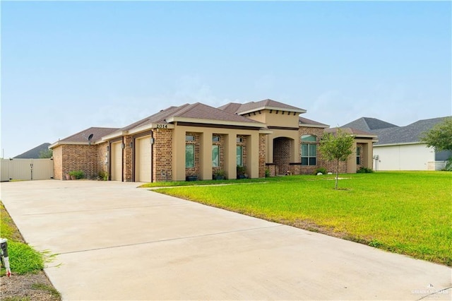 2014 Thacker Ln, Harlingen, TX 78552 - view of front of home featuring concrete driveway, an attached garage, and brick siding
