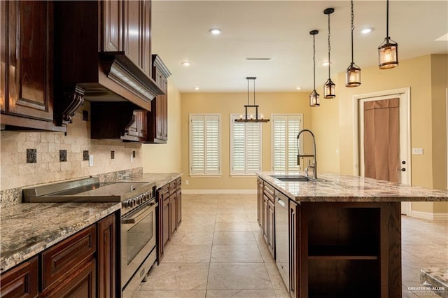 2014 Thacker Ln, Harlingen, TX 78552 - kitchen featuring high end stove, backsplash, hanging light fixtures, light stone countertops, and recessed lighting