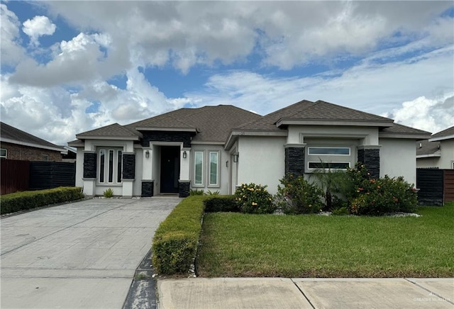 prairie-style home featuring a front yard