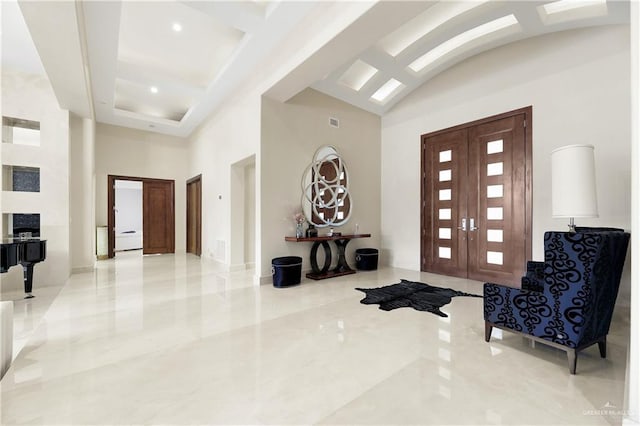 foyer entrance with marble finish floor, french doors, visible vents, high vaulted ceiling, and coffered ceiling