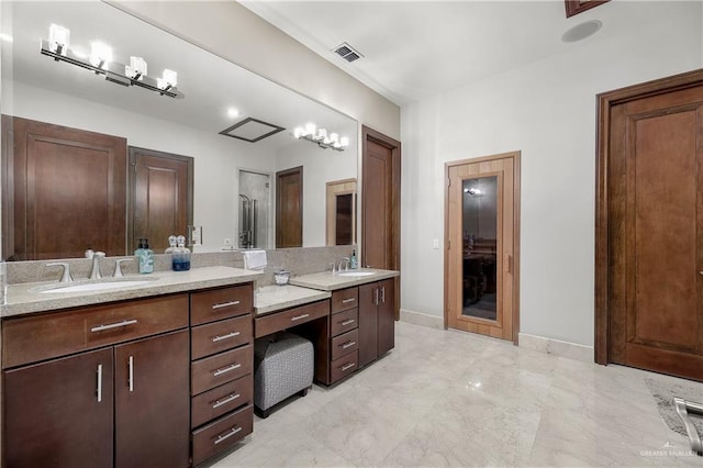 bathroom featuring marble finish floor, baseboards, visible vents, and vanity