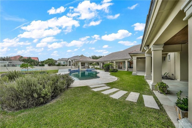 view of yard with a fenced in pool and a patio