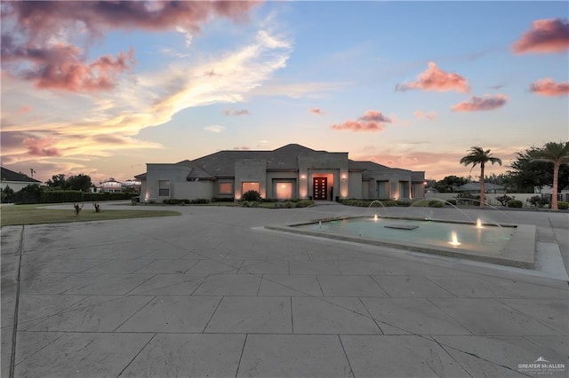 view of pool at dusk