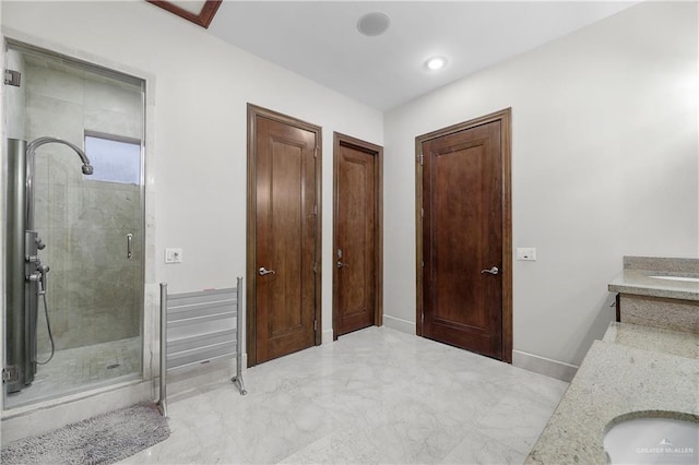 bathroom featuring marble finish floor, recessed lighting, a shower stall, vanity, and baseboards