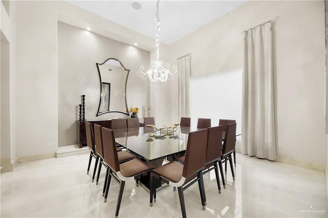 dining area with an inviting chandelier and baseboards