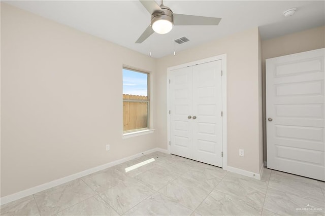 unfurnished bedroom featuring ceiling fan and a closet