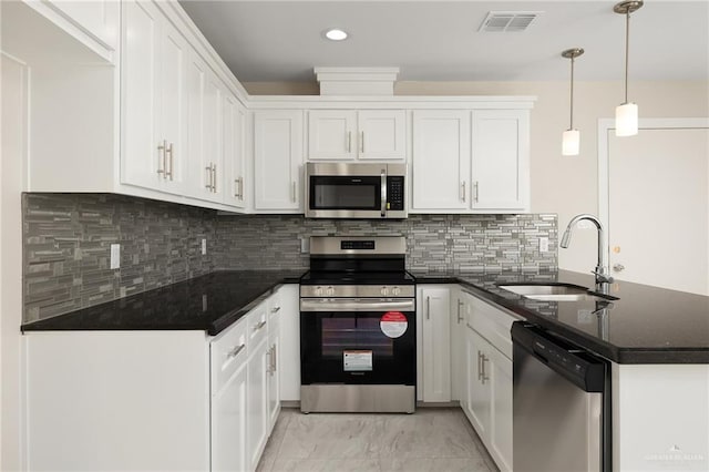 kitchen featuring sink, hanging light fixtures, white cabinets, and appliances with stainless steel finishes