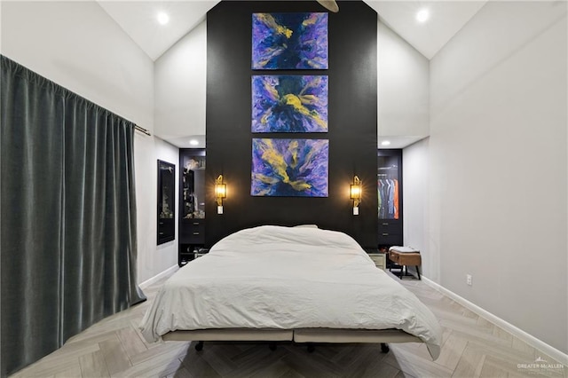 bedroom featuring high vaulted ceiling and light parquet flooring