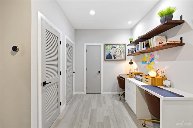 office with light wood-type flooring