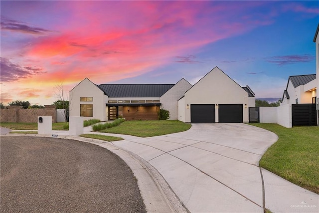 modern inspired farmhouse with a yard and a garage