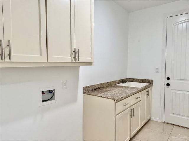 washroom with washer hookup, cabinet space, a sink, and light tile patterned flooring