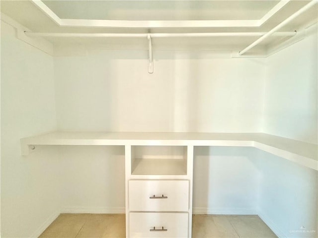 spacious closet featuring light tile patterned floors