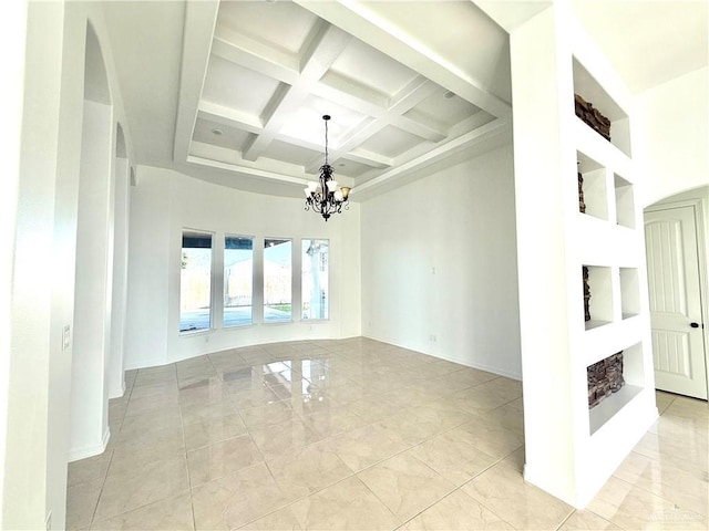 spare room with a high ceiling, coffered ceiling, baseboards, beam ceiling, and an inviting chandelier