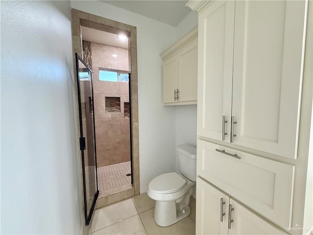 full bath featuring toilet, a shower stall, and tile patterned flooring