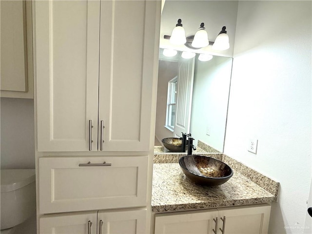 bathroom with toilet and vanity