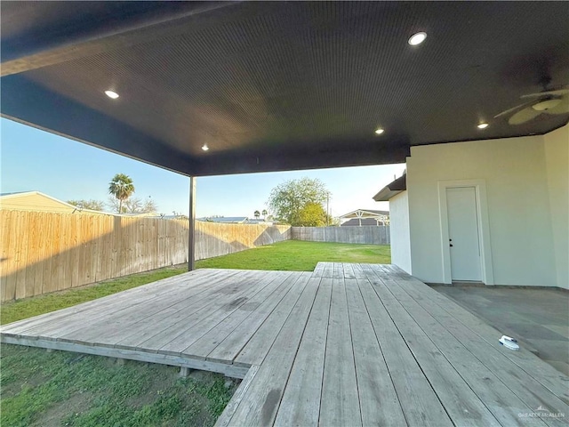 wooden deck featuring a lawn and a fenced backyard