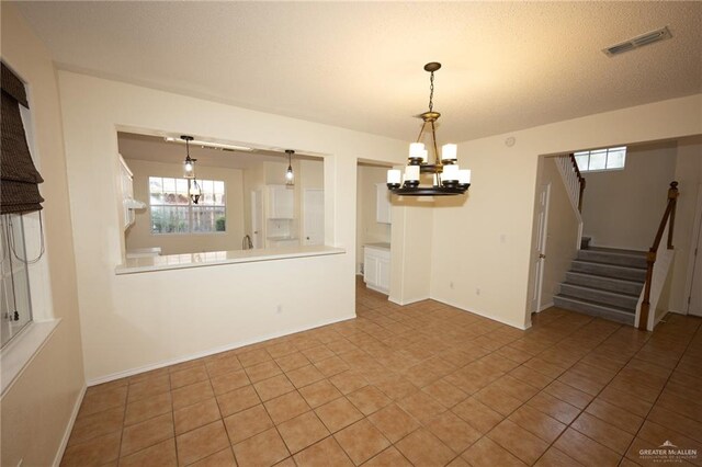 interior space featuring light tile patterned flooring and a chandelier