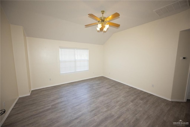 unfurnished room with dark hardwood / wood-style floors, vaulted ceiling, and ceiling fan