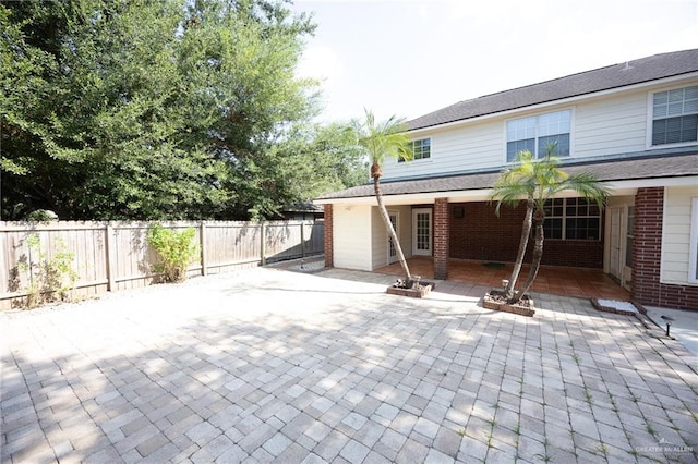 rear view of property featuring a patio area