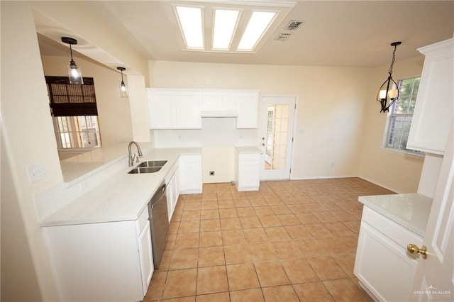 kitchen featuring white cabinetry, sink, dishwasher, and light tile patterned floors