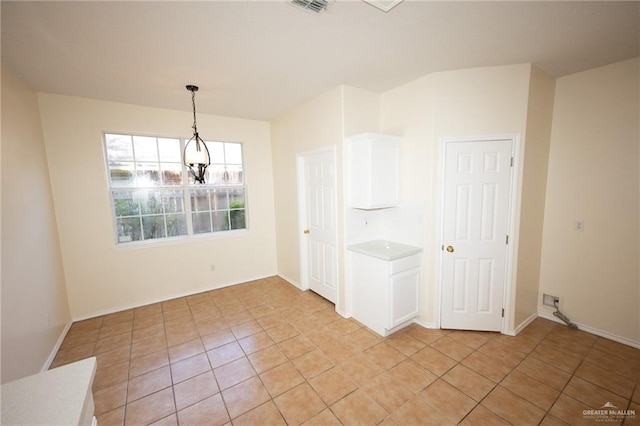 unfurnished dining area with light tile patterned floors