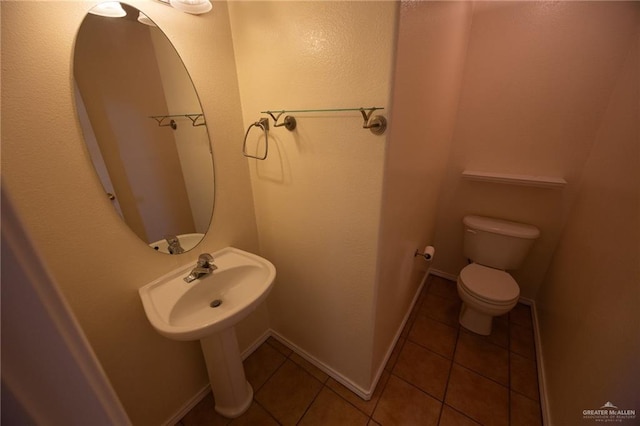 bathroom with tile patterned floors and toilet