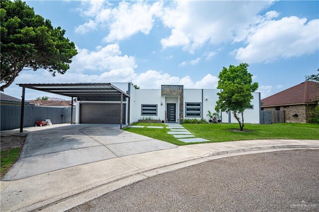 contemporary house featuring a carport, stucco siding, driveway, and an attached garage