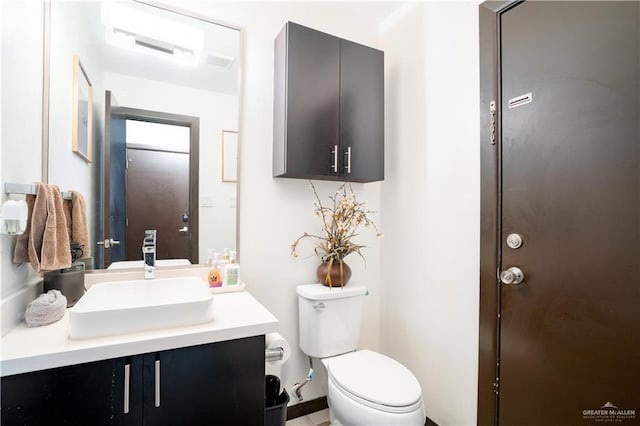 bathroom featuring toilet and vanity
