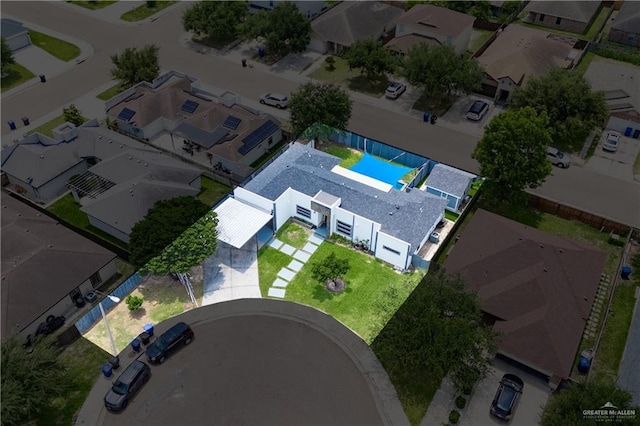 aerial perspective of suburban area featuring a pool area