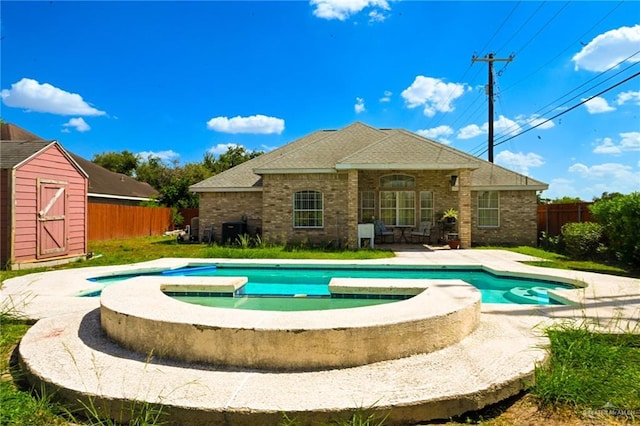 view of pool with a storage unit and an in ground hot tub