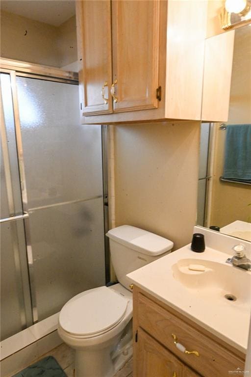 bathroom with vanity, toilet, and walk in shower