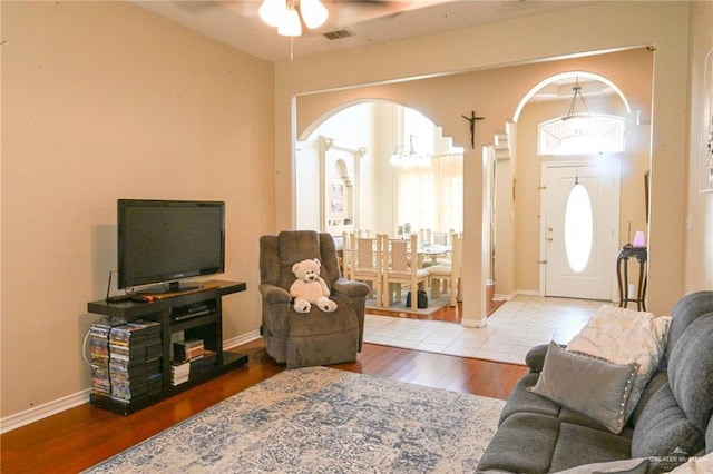 living room featuring ceiling fan and wood-type flooring