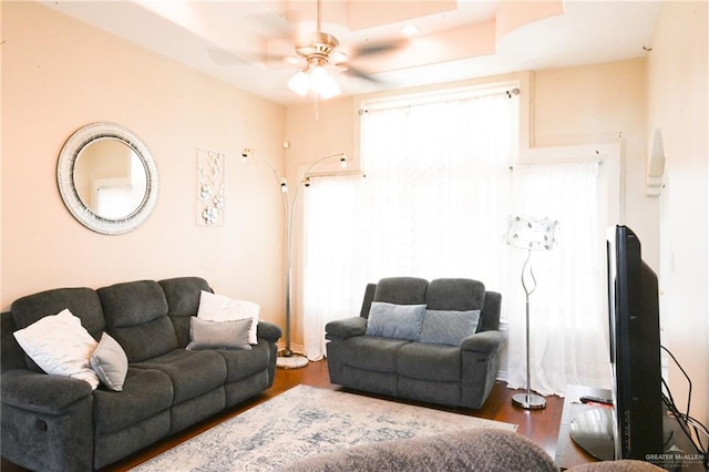 living room with ceiling fan, a healthy amount of sunlight, and dark hardwood / wood-style floors