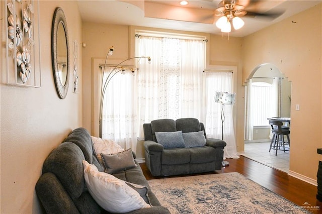 living room with ceiling fan and wood-type flooring