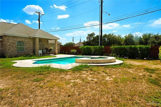 view of pool with an in ground hot tub and a yard