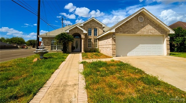 view of front of home featuring a front yard and a garage